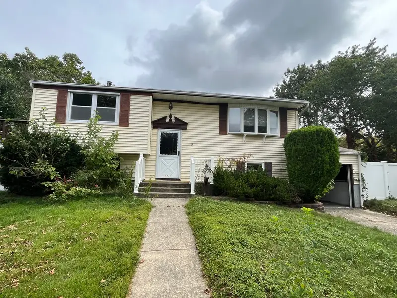 Raised ranch with a straight front walk across the lawn, Northport, NY